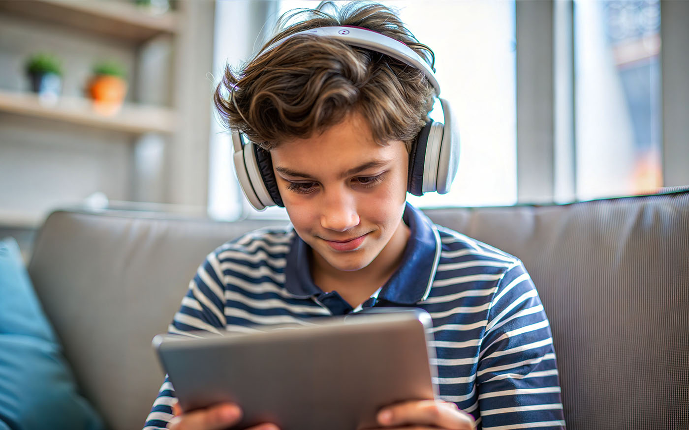 A preteen boy in his home engaged in a multimedia learning session.